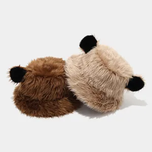 Detailed closeup view of plush bear ear bucket hats in brown and khaki, warm winter design.