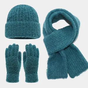 Vista detallada del juego de gorro bufanda y guantes de punto suave y cálido en azul.