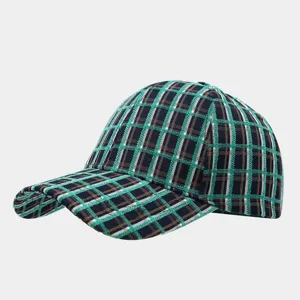 Detail view of vintage color-blocking plaid baseball cap, cozy tweed fabric for winter.