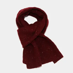 Vista detallada en primer plano de una elegante bufanda de punto rojo oscuro con lentejuelas.
