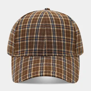 Close-up detail of vintage brown plaid baseball cap, showing textured fabric and neat stitching.