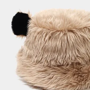Close-up detail of fluffy faux fur bucket hat with cute bear ears, soft winter warm plush hat.
