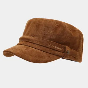 Detailed view of brown suede military cap with side embroidery and metal buckle.