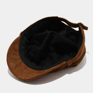 Brown suede flat cap inner lining and metal buckle detail view for cold winter wear.