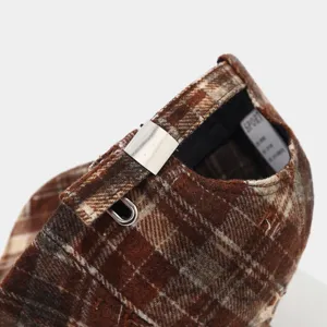 Retro brown plaid baseball cap detail, vintage distressed fabric with adjustable metal buckle.
