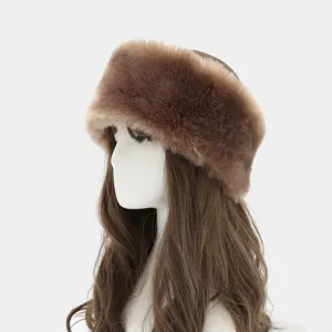 Detail shot of plush fluffy brown winter ear warmer headband texture and thick faux fur fabric.