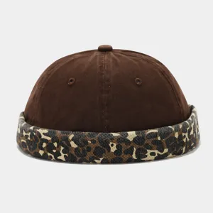 Detail view of brown docker hat with trendy leopard print brim. Stylish street fashion cap.