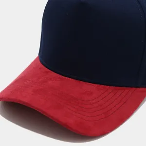 Close-up view of the red suede visor and dark blue crown patchwork baseball cap detail.