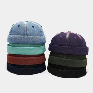 Detailed view of retro washed denim docker caps, stylish brimless rolled edge hats for street wear.