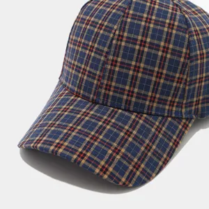 Classic plaid baseball cap detail, retro navy blue check pattern, stylish autumn sun hat.