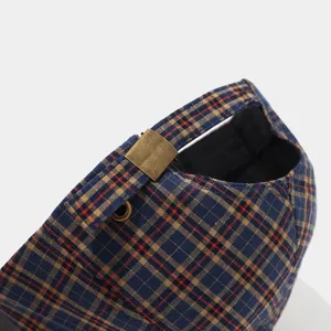 Close-up of retro plaid baseball cap back strap with metal buckle, casual stylish hat.