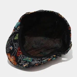 Close-up detail view of the retro butterfly jacquard flat cap interior and fabric texture.