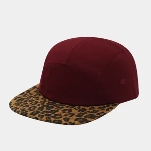 Detail shot of five-panel cap with burgundy crown and stylish leopard print flat brim.