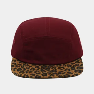 Maroon 5-panel cap with leopard print flat brim detail, stylish streetwear accessory.