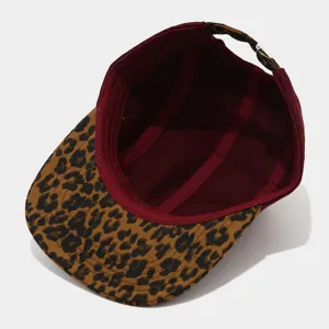 Detailed view of the 5-panel flat brim cap featuring leopard print visor and maroon crown inside.