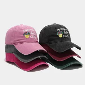Detailed view of washed dad baseball cap with floral embroidery and garden text for outdoor wear.