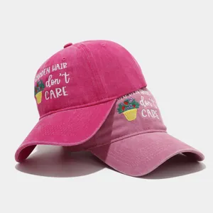 Washed pink dad baseball cap featuring cute floral pot embroidery and Garden Hair slogan detail.