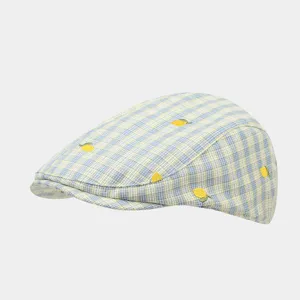 Details of blue yellow plaid ivy cap featuring cute embroidered yellow lemon patterns.
