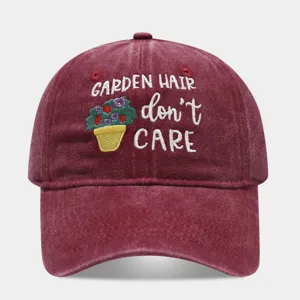 Detailed view of a vintage washed burgundy baseball cap with cute garden floral embroidery text.