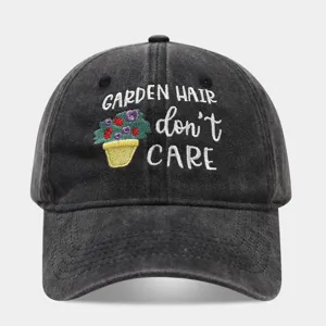 Washed black dad hat featuring embroidered gardening floral design and slogan text on front.