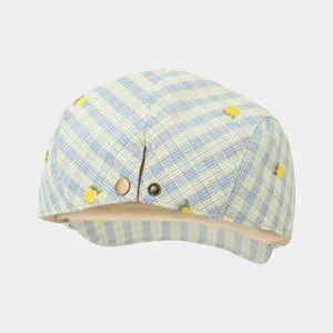 Detailed view of blue yellow plaid flat cap with cute embroidered lemon and metal button.