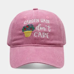 Pink washed dad hat detail, garden hair dont care embroidery, casual baseball cap style.