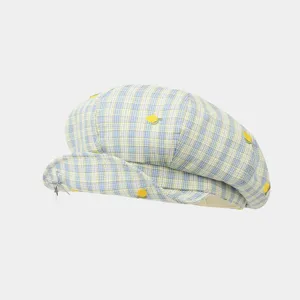 Detailed view of the cute blue and yellow plaid beret hat featuring lemon embroidery.