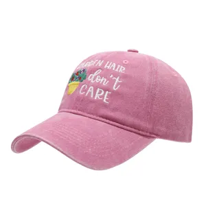 Pink washed dad hat with floral embroidery, casual baseball cap for outdoor sun protection.