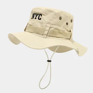 Detail view of khaki bucket hat featuring NYC embroidery, metal eyelets and chin cord.
