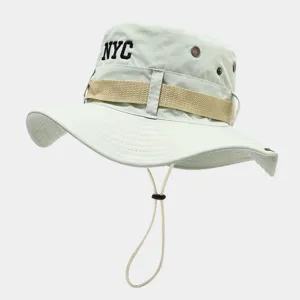 Close-up detail of the breathable bucket hat featuring embroidered NYC letters and web strap.