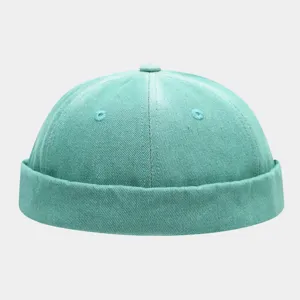 Close-up of the washed gradient denim docker cap showing fine stitching and texture.