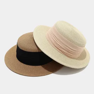 French vintage flat-top straw hat set with wide ribbon detail, ideal for summer beach vacation.