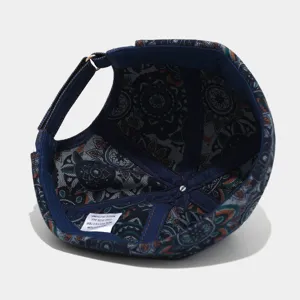 Detailed view of vintage washed denim docker cap with paisley lining and adjustable strap.