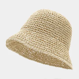 Detail shot of the breathable hollow straw bucket hat, showing fine woven texture for summer.