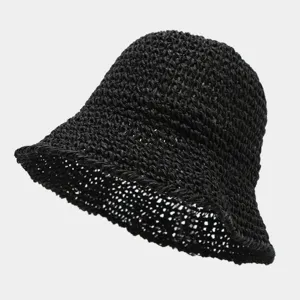 Detailed view of the black woven straw bucket hat texture, breathable summer beach sun hat.