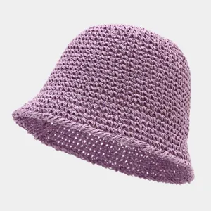 Close-up of the breathable hollow-out straw bucket hat texture, lightweight summer beach style.