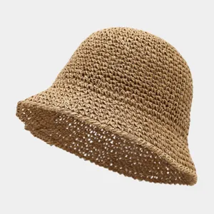 Detailed view of the summer breathable hollow straw bucket hat in chic khaki color texture.
