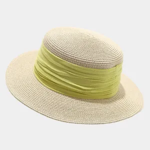 Detail shot of a French retro flat-top straw hat featuring a wide light green ribbon accent.