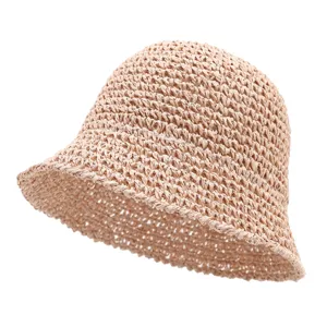 Summer straw bucket hat for women, breathable hollow-out beach sun hat in solid beige color.
