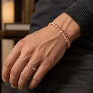 Close-up detail of vintage style copper twist open bracelet and matching ring set for couples.