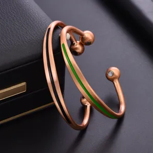 Copper magnetic therapy bracelet detail shot, adjustable open bangle with colored enamel lines.