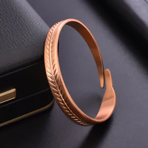 Exquisite copper feather cuff bracelet detail, adjustable open design, elegant rose gold finish.