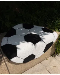 Round football shaped floor mat with thickened flocking, soft and absorbent for home decor.