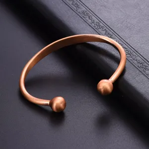 Vintage copper open cuff bracelet with dual round ball ends, stylish magnetic therapy wristband.