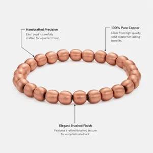 Closeup detail of handcrafted pure copper beaded bracelet showing elegant brushed finish texture.
