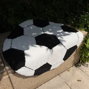 Round soccer rug detail showing plush black and white football pattern, fluffy home decor mat.