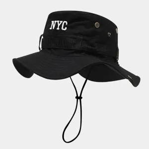 Close-up detail of black bucket hat featuring white NYC embroidery, breathable metal eyelets.