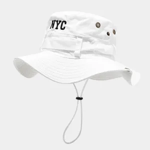 Detail view of white bucket hat featuring NYC embroidery, metal eyelets, and adjustable chin cord.