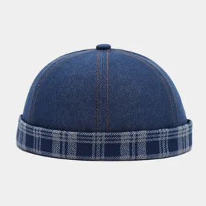 Detail view of the stylish denim docker cap featuring a contrasting blue plaid rolled brim.