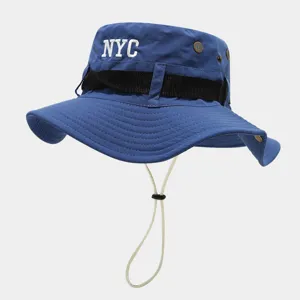 Detailed view of blue outdoor bucket hat featuring NYC embroidery, black webbed band and adjustable chin cord.